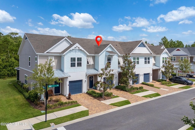 30 Yeti Ct, Saint Augustine, FL 32092 - multi unit property with a standing seam roof, an attached garage, decorative driveway, and roof with shingles