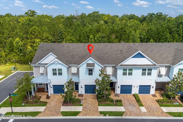 30 Yeti Ct, Saint Augustine, FL 32092 - townhome / multi-family property featuring a standing seam roof, a metal roof, a garage, and a wooded view