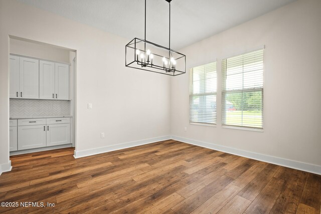 36250 Pitch Ln, Hilliard, FL 32046 - unfurnished dining area with a chandelier and dark wood-style floors