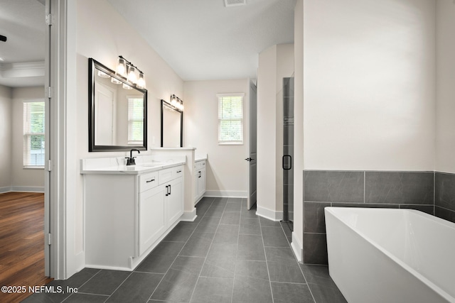 36250 Pitch Ln, Hilliard, FL 32046 - bathroom featuring a freestanding bath, vanity, a shower stall, and tile patterned floors