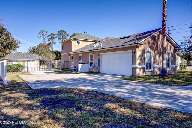 1700 Southcreek Dr, Saint Johns, FL 32259 - view of side of property featuring a gate, a garage, and driveway