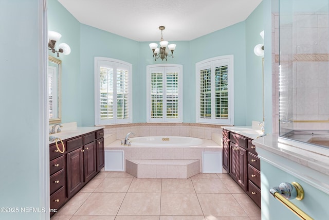 1700 Southcreek Dr, Saint Johns, FL 32259 - full bath with two vanities, a garden tub, tile patterned floors, and a chandelier