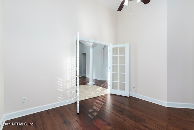 1700 Southcreek Dr, Saint Johns, FL 32259 - spare room with decorative columns, wood-type flooring, ceiling fan, arched walkways, and french doors