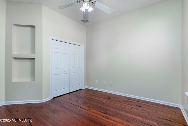 1700 Southcreek Dr, Saint Johns, FL 32259 - unfurnished bedroom with dark wood finished floors, a closet, a textured ceiling, and a ceiling fan