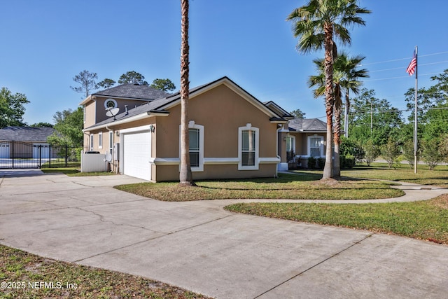 1700 Southcreek Dr, Saint Johns, FL 32259 - view of home's exterior with concrete driveway, stucco siding, and a garage