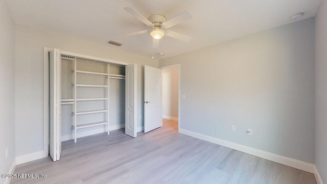 99 Sloganeer Trl, Palm Coast, FL 32164 - unfurnished bedroom with light wood finished floors, a closet, and a ceiling fan