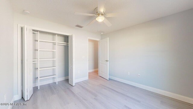 99 Sloganeer Trl, Palm Coast, FL 32164 - unfurnished bedroom with light wood finished floors, a closet, and ceiling fan
