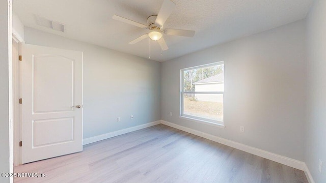 99 Sloganeer Trl, Palm Coast, FL 32164 - empty room featuring light wood finished floors and a ceiling fan