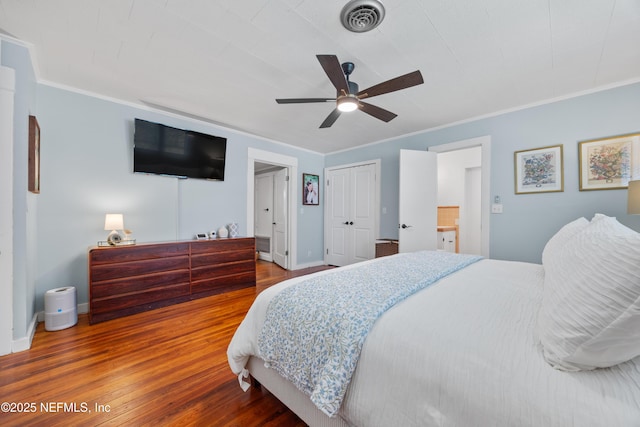 117 Parshley St SW, Live Oak, FL 32064 - bedroom featuring wood finished floors, crown molding, a ceiling fan, and a closet