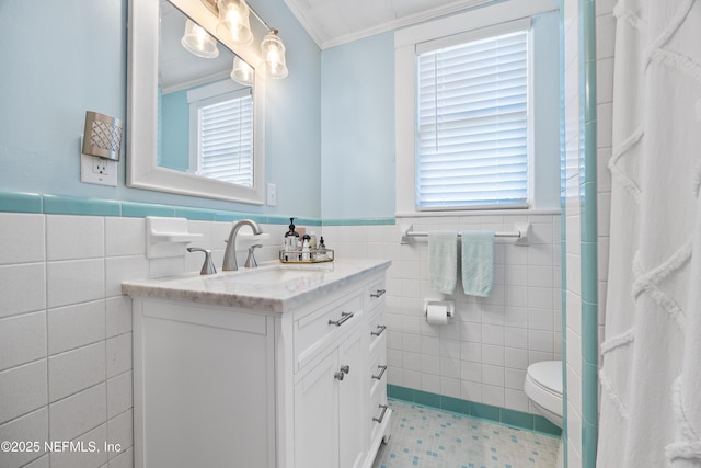 117 Parshley St SW, Live Oak, FL 32064 - full bath with tile walls, vanity, a wainscoted wall, a shower with shower curtain, and crown molding