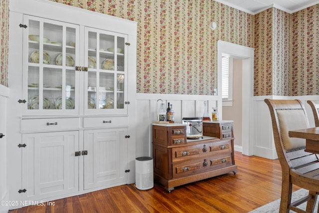 117 Parshley St SW, Live Oak, FL 32064 - bar area featuring wallpapered walls, a wainscoted wall, wood finished floors, ornamental molding, and a decorative wall
