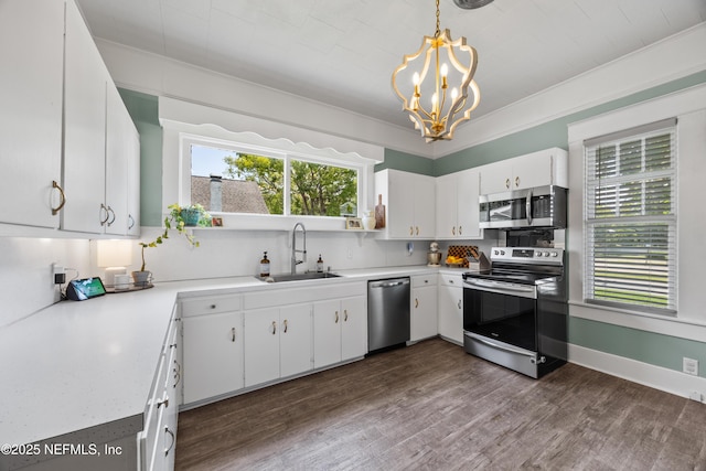 117 Parshley St SW, Live Oak, FL 32064 - kitchen featuring stainless steel appliances, a chandelier, light countertops, backsplash, and white cabinets