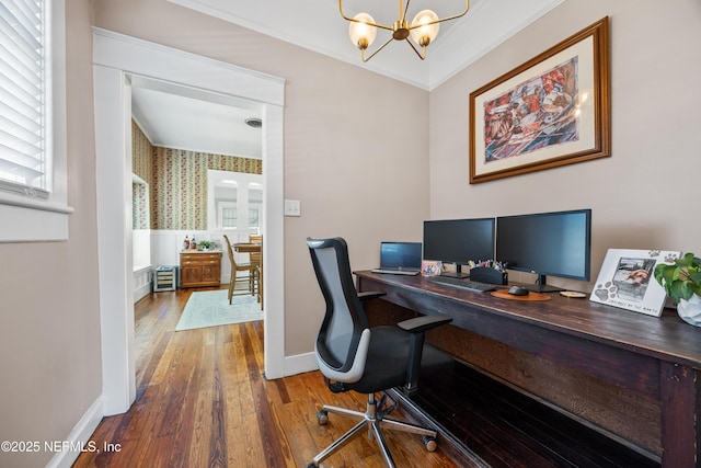 117 Parshley St SW, Live Oak, FL 32064 - office area featuring a chandelier, wood-type flooring, ornamental molding, wallpapered walls, and healthy amount of natural light