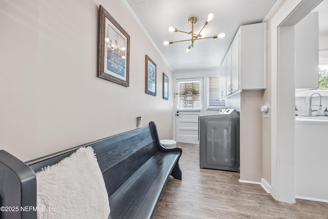 117 Parshley St SW, Live Oak, FL 32064 - laundry room featuring washer / clothes dryer, a chandelier, crown molding, healthy amount of natural light, and wood finished floors