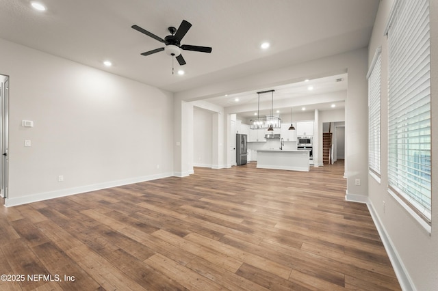 36258 Pitch Ln, Hilliard, FL 32046 - unfurnished living room featuring wood finished floors, ceiling fan, and recessed lighting
