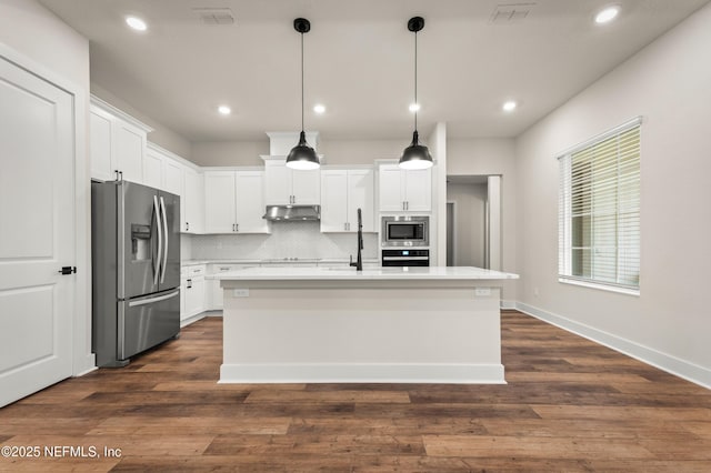 36258 Pitch Ln, Hilliard, FL 32046 - kitchen with black appliances, light countertops, under cabinet range hood, white cabinets, and tasteful backsplash