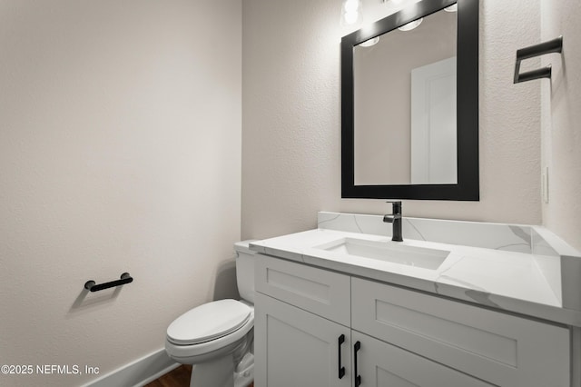 36258 Pitch Ln, Hilliard, FL 32046 - half bath featuring vanity, wood finished floors, and a textured wall
