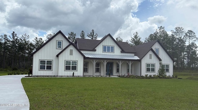 36258 Pitch Ln, Hilliard, FL 32046 - modern inspired farmhouse with board and batten siding, a porch, a front yard, and a metal roof