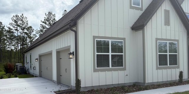 36258 Pitch Ln, Hilliard, FL 32046 - view of property exterior with roof with shingles, a garage, driveway, and board and batten siding