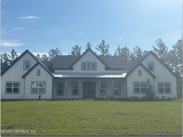 36258 Pitch Ln, Hilliard, FL 32046 - view of front of house with a front lawn, board and batten siding, a metal roof, and a standing seam roof