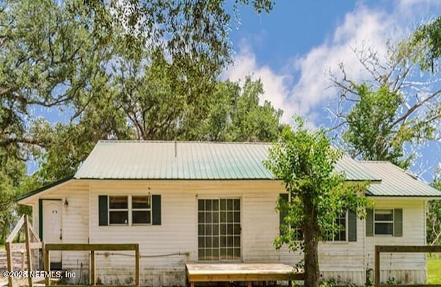 14344 68th St, Live Oak, FL 32060 - rear view of property with a metal roof and a deck