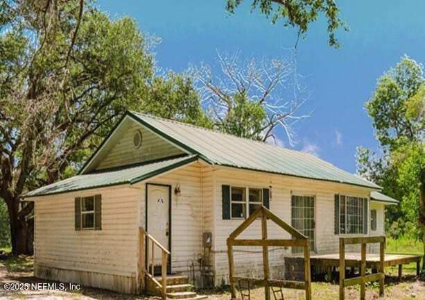 14344 68th St, Live Oak, FL 32060 - back of property with entry steps and a metal roof