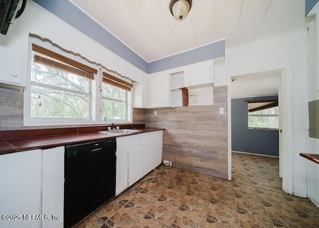 14344 68th St, Live Oak, FL 32060 - kitchen featuring black dishwasher, dark countertops, white cabinetry, and backsplash
