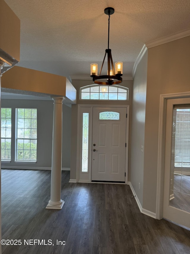 1032 Durbin Parke Dr, Jacksonville, FL 32259 - foyer entrance with decorative columns, crown molding, a chandelier, dark wood-style floors, and a textured ceiling