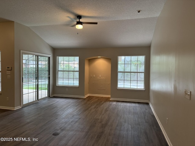 1032 Durbin Parke Dr, Jacksonville, FL 32259 - empty room with a ceiling fan, arched walkways, a textured ceiling, dark wood finished floors, and lofted ceiling