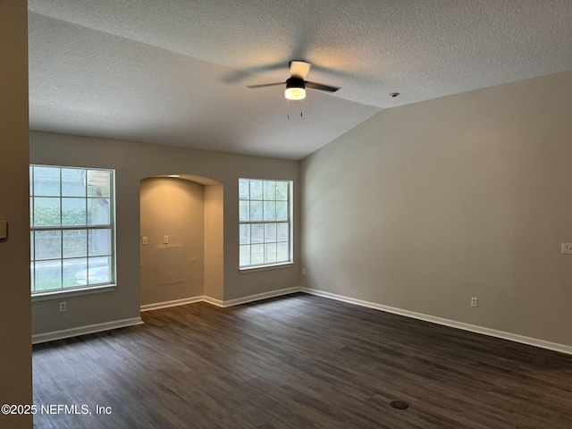 1032 Durbin Parke Dr, Jacksonville, FL 32259 - empty room with arched walkways, a ceiling fan, dark wood-style floors, a textured ceiling, and vaulted ceiling