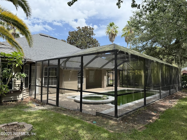 1032 Durbin Parke Dr, Jacksonville, FL 32259 - rear view of property featuring roof with shingles, a patio area, a lanai, and a pool with connected hot tub