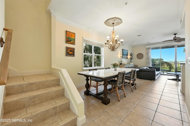 2201 Windjammer Ln, Saint Augustine, FL 32084 - dining room with ornamental molding, light tile patterned flooring, stairs, a chandelier, and ceiling fan