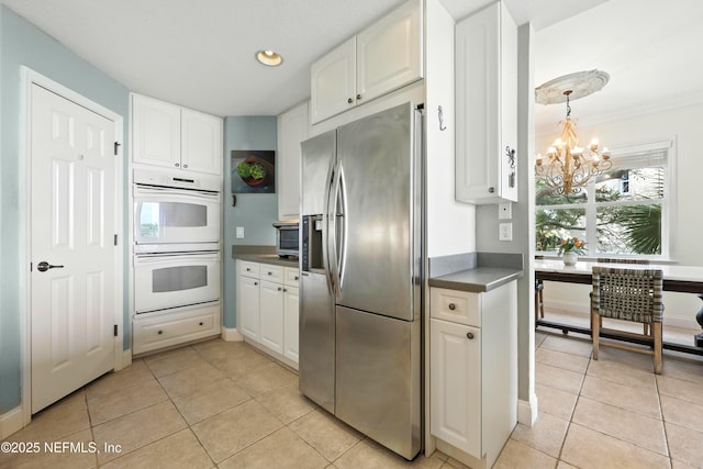 2201 Windjammer Ln, Saint Augustine, FL 32084 - kitchen featuring stainless steel refrigerator with ice dispenser, double oven, a chandelier, white cabinetry, and recessed lighting