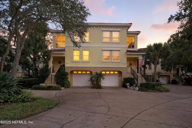 2201 Windjammer Ln, Saint Augustine, FL 32084 - multi unit property featuring stairs, a balcony, stucco siding, concrete driveway, and a garage