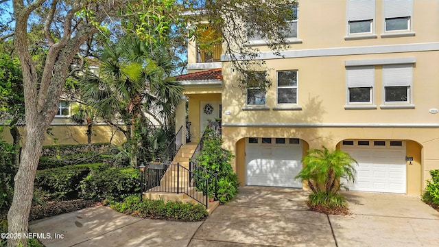 2201 Windjammer Ln, Saint Augustine, FL 32084 - townhome / multi-family property with a garage, concrete driveway, stucco siding, and stairway