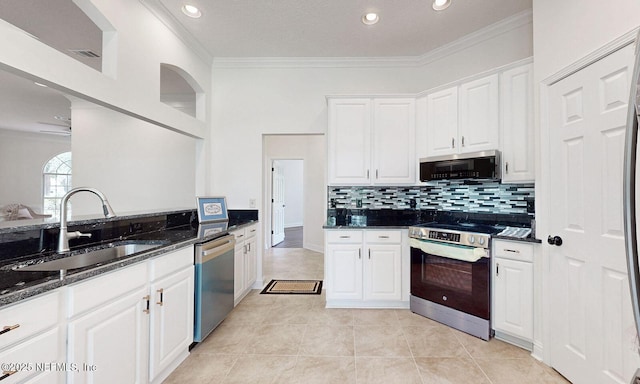 1877 Medinah Ln, Green Cove Springs, FL 32043 - kitchen with stainless steel appliances, ornamental molding, dark stone counters, white cabinets, and backsplash