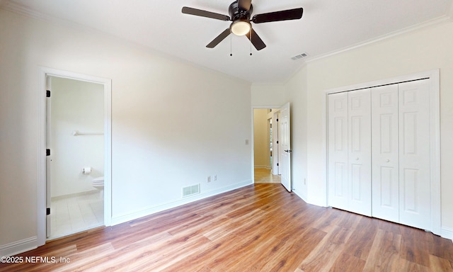 1877 Medinah Ln, Green Cove Springs, FL 32043 - unfurnished bedroom featuring ornamental molding, wood finished floors, a closet, ensuite bathroom, and ceiling fan