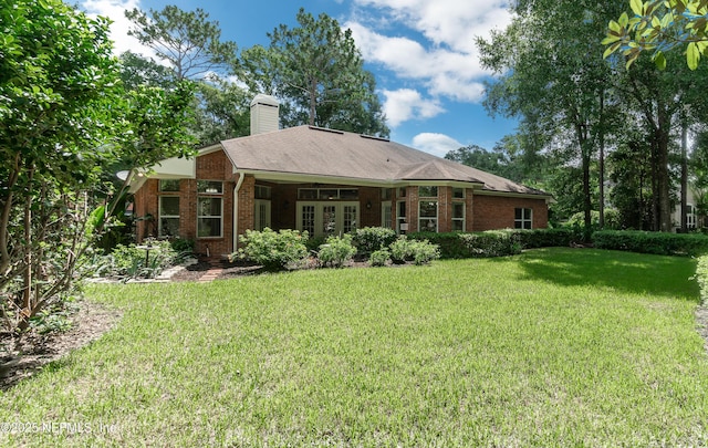 1877 Medinah Ln, Green Cove Springs, FL 32043 - rear view of property with a yard, brick siding, and a chimney