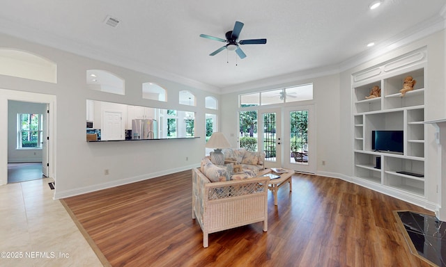 1877 Medinah Ln, Green Cove Springs, FL 32043 - living room with french doors, ceiling fan, crown molding, wood finished floors, and built in features