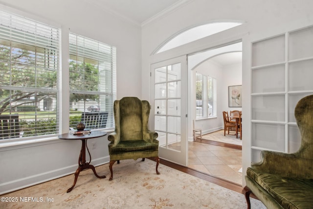85488 Sagaponack Dr, Fernandina Beach, FL 32034 - sitting room featuring crown molding, plenty of natural light, wood finished floors, arched walkways, and french doors