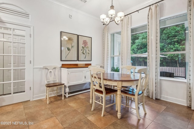 85488 Sagaponack Dr, Fernandina Beach, FL 32034 - dining area featuring ornamental molding and a chandelier