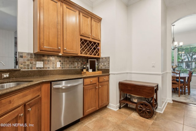 85488 Sagaponack Dr, Fernandina Beach, FL 32034 - kitchen featuring stainless steel dishwasher, ornamental molding, brown cabinets, and a chandelier