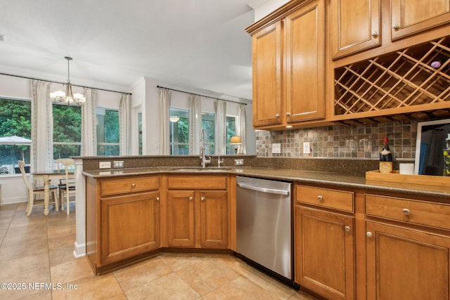 85488 Sagaponack Dr, Fernandina Beach, FL 32034 - kitchen with dishwasher, healthy amount of natural light, brown cabinets, a chandelier, and ornamental molding