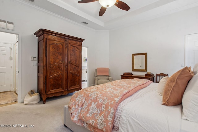 85488 Sagaponack Dr, Fernandina Beach, FL 32034 - bedroom featuring light carpet, ensuite bath, ceiling fan, ornamental molding, and a tray ceiling