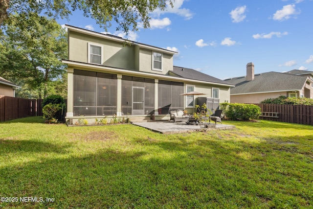 85488 Sagaponack Dr, Fernandina Beach, FL 32034 - rear view of property featuring a sunroom, a patio, a fenced backyard, and stucco siding