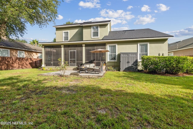 85488 Sagaponack Dr, Fernandina Beach, FL 32034 - back of house featuring a sunroom, a patio area, and stucco siding