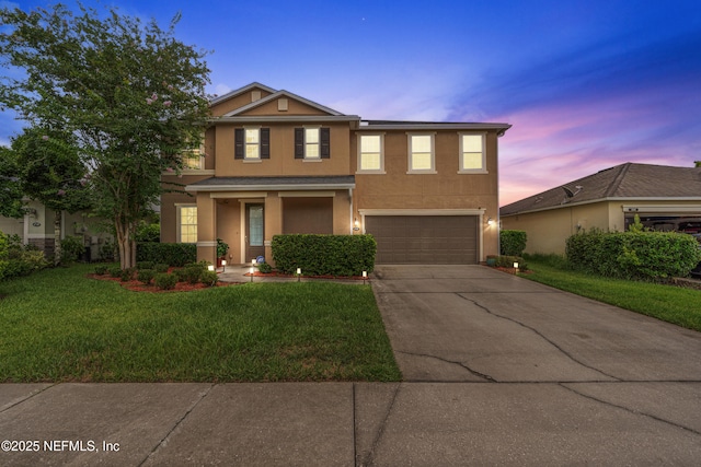 4749 Creek Bluff Ln, Middleburg, FL 32068 - traditional-style house featuring an attached garage, stucco siding, concrete driveway, and a yard