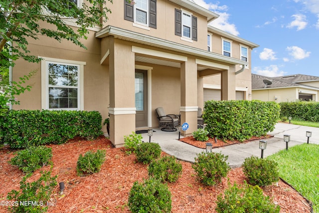 4749 Creek Bluff Ln, Middleburg, FL 32068 - entrance to property with stucco siding and covered porch