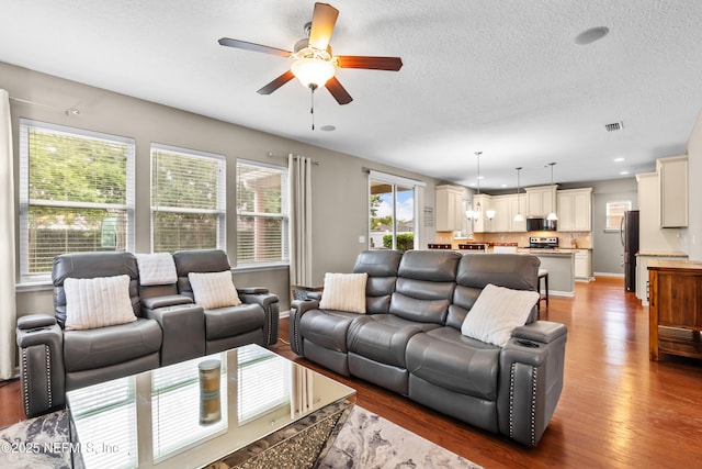 4749 Creek Bluff Ln, Middleburg, FL 32068 - living area with a ceiling fan, wood finished floors, a textured ceiling, and recessed lighting