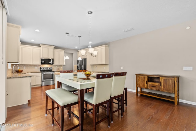4749 Creek Bluff Ln, Middleburg, FL 32068 - dining room with recessed lighting, dark wood-style floors, and a chandelier